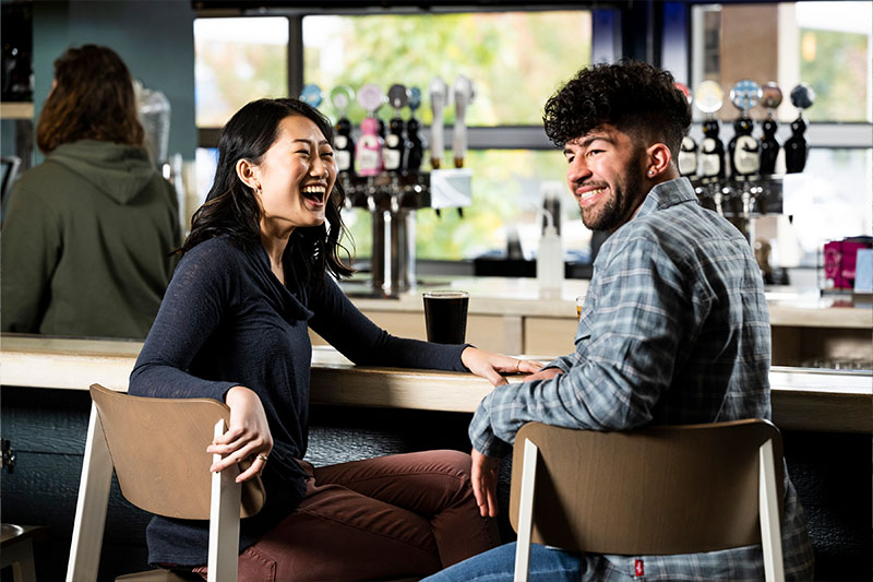 A couple laughing at One Barrel Brewing Company, a popular winter thing to do in Door County.
