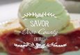 The words Savor Door County over an image of a cherry pie with ice cream.